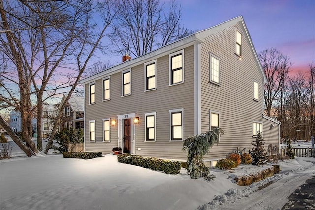 colonial inspired home with a chimney