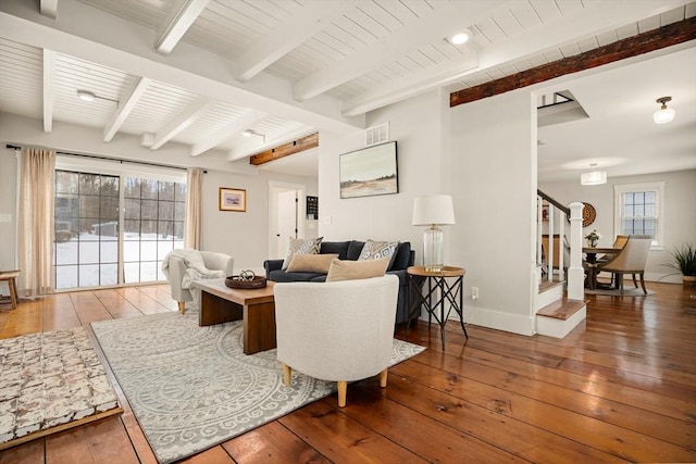 living room featuring wood-type flooring, a healthy amount of sunlight, and stairway