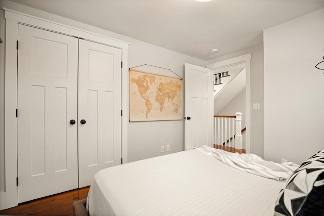 bedroom with a closet and dark wood finished floors