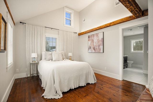 bedroom featuring wood-type flooring, visible vents, ensuite bath, and baseboards