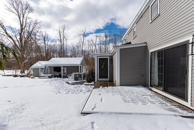 view of snow covered rear of property