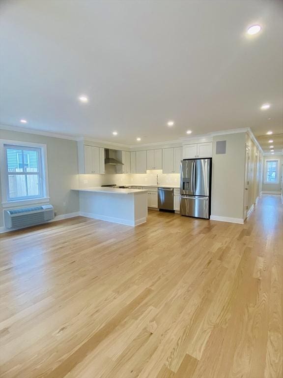 15 Yuill Cir, Boston, MA 02136 - kitchen with appliances with stainless steel finishes, wall chimney range hood, crown molding, white cabinets, and baseboards
