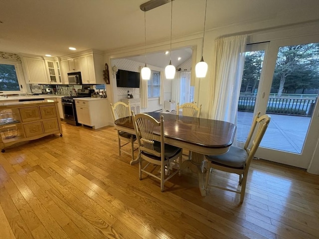 dining room with recessed lighting and light wood-style flooring