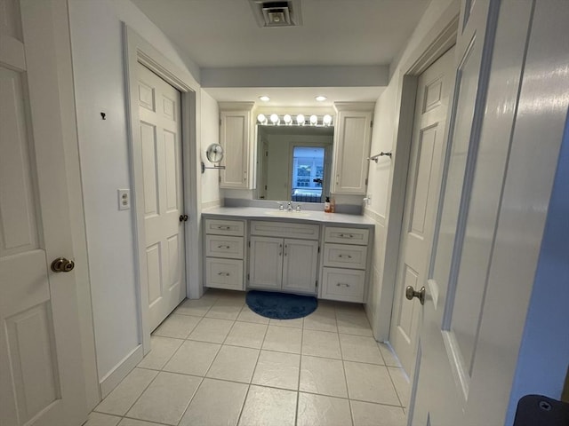 bathroom featuring vanity, visible vents, tile patterned floors, and baseboards