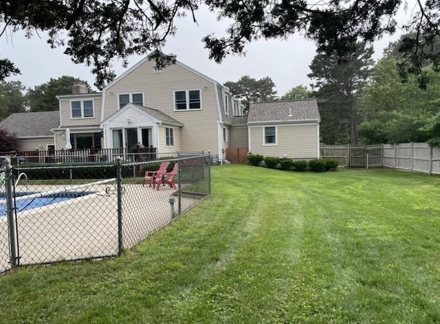 back of property with a lawn, a patio area, and a fenced backyard