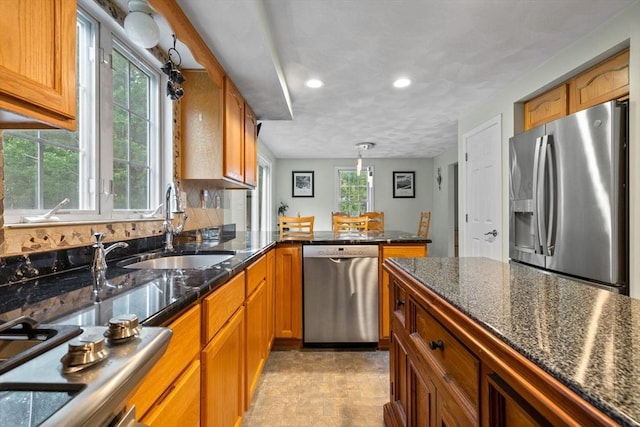 7 Suzannah Rd, Billerica, MA 01862 - kitchen featuring appliances with stainless steel finishes, brown cabinetry, recessed lighting, a peninsula, and dark stone countertops