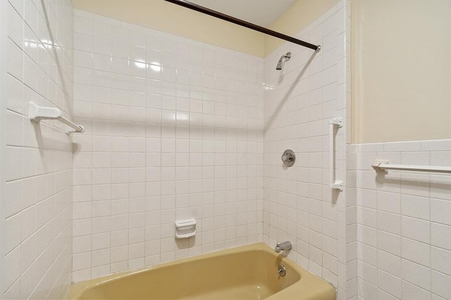 full bathroom with wainscoting and tub / shower combination