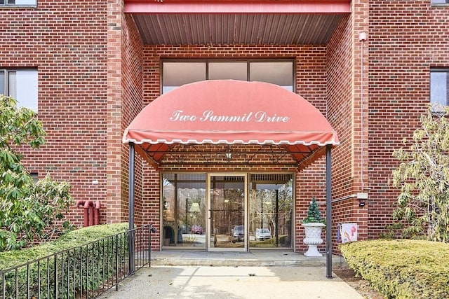 view of exterior entry with brick siding