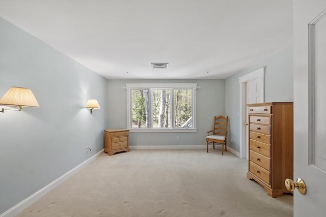 sitting room with carpet flooring, baseboards, and visible vents