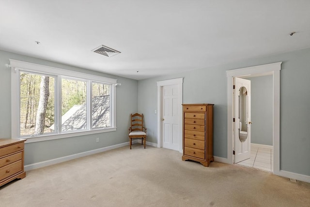 sitting room with baseboards, visible vents, light carpet, and plenty of natural light