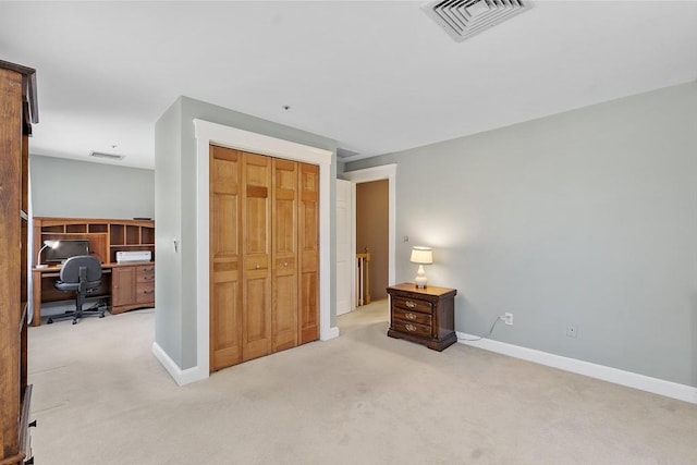 carpeted bedroom featuring baseboards, visible vents, and a closet