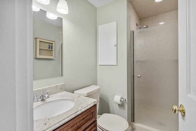 full bathroom with vanity, a stall shower, and toilet