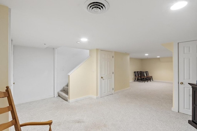 finished basement with visible vents, stairs, baseboards, recessed lighting, and carpet flooring