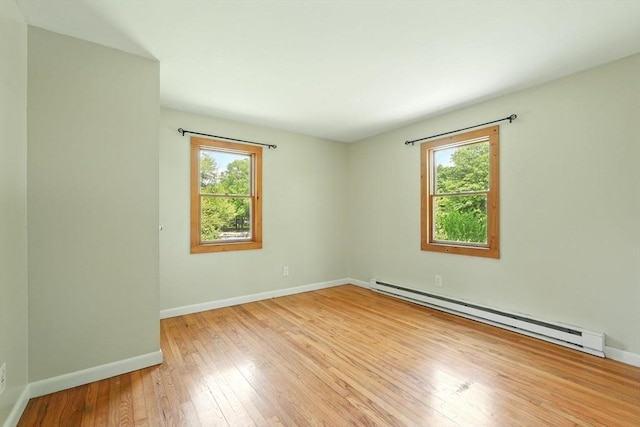 161 Farmington Rd, Amherst, MA 01002 - spare room with a baseboard heating unit, healthy amount of natural light, hardwood / wood-style floors, and baseboards