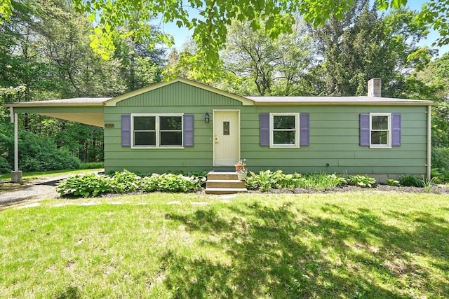 161 Farmington Rd, Amherst, MA 01002 - view of front of home with driveway, a front yard, a chimney, and view of wooded area