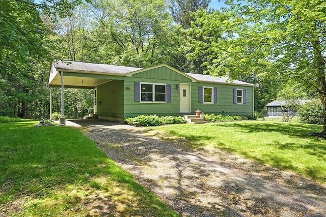161 Farmington Rd, Amherst, MA 01002 - view of front facade with driveway, a front lawn, entry steps, and an attached carport