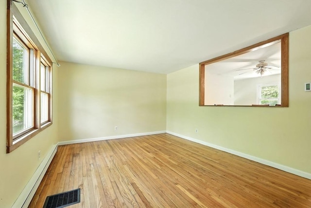 161 Farmington Rd, Amherst, MA 01002 - spare room with a baseboard radiator, hardwood / wood-style flooring, baseboards, and plenty of natural light