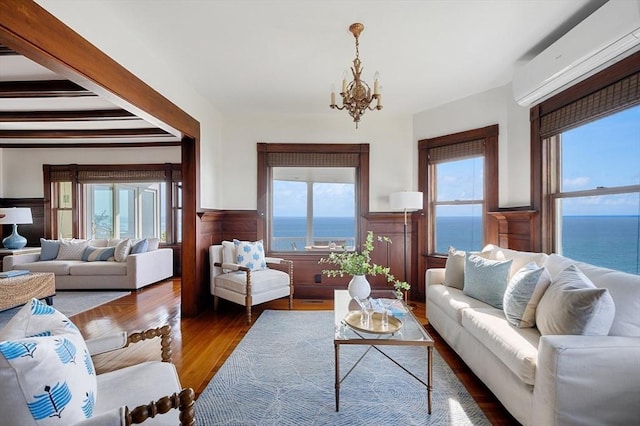2 Bluff Rd, Hull, MA 02045 - living room featuring a wall mounted air conditioner, wainscoting, a chandelier, a water view, and wood finished floors