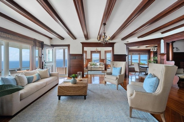2 Bluff Rd, Hull, MA 02045 - living area with a chandelier, healthy amount of natural light, beamed ceiling, and wood finished floors