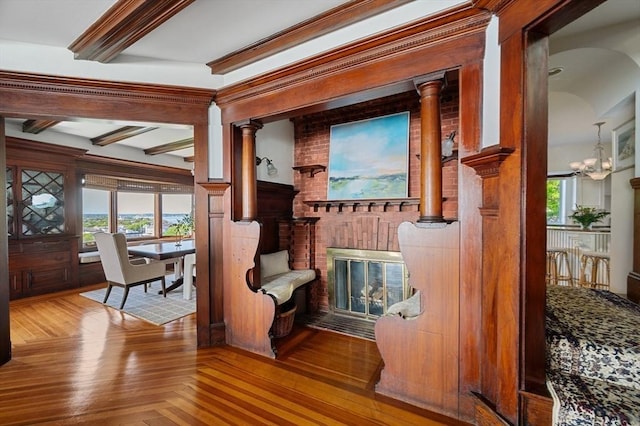 2 Bluff Rd, Hull, MA 02045 - detailed view of beamed ceiling, a fireplace, a chandelier, and wood finished floors