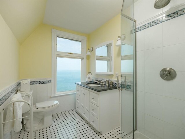 2 Bluff Rd, Hull, MA 02045 - full bath with tiled shower, toilet, healthy amount of natural light, a wainscoted wall, and lofted ceiling