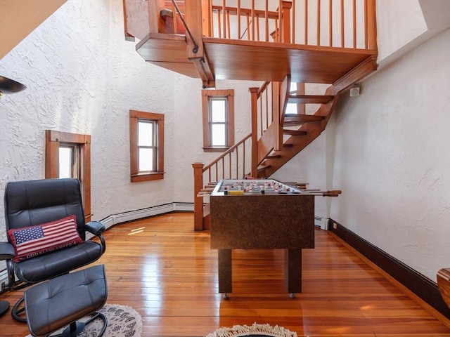 2 Bluff Rd, Hull, MA 02045 - game room with a textured wall, hardwood / wood-style flooring, baseboard heating, and baseboards