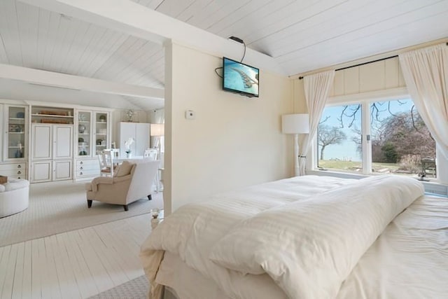 bedroom featuring lofted ceiling with beams and carpet