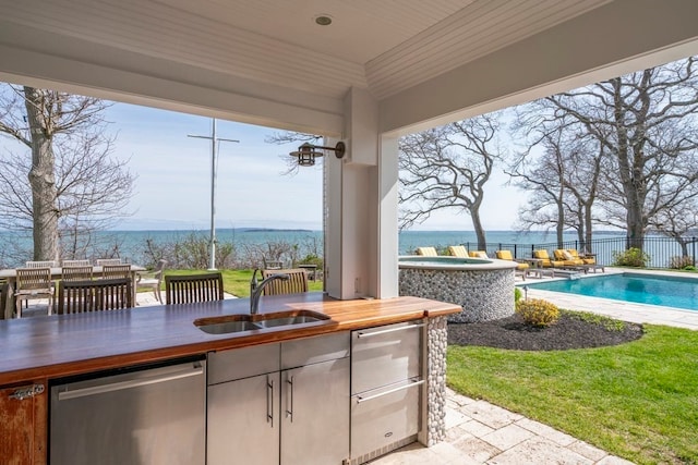 view of terrace featuring sink and a fenced in pool