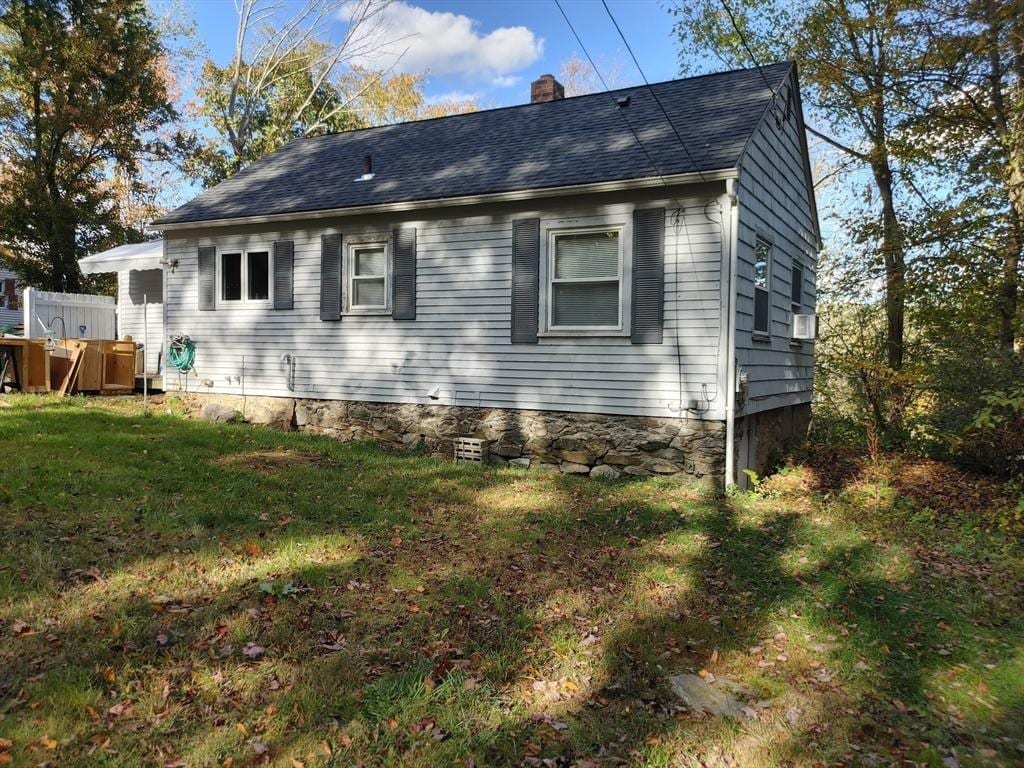 view of side of property with a yard