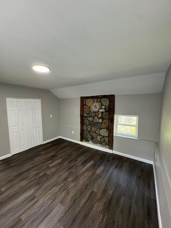32 Main St, Monson, MA 01057 - unfurnished living room with vaulted ceiling and dark wood-style floors