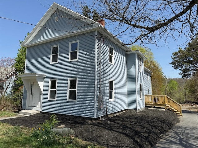32 Main St, Monson, MA 01057 - view of side of property featuring a chimney and a deck