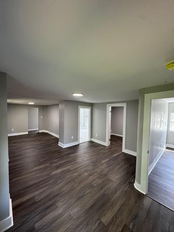 32 Main St, Monson, MA 01057 - unfurnished living room with baseboards and dark wood-type flooring