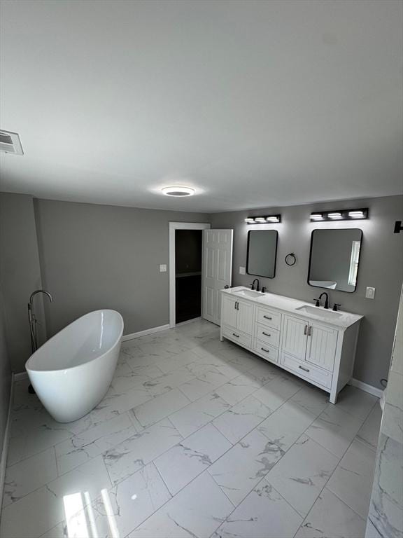 32 Main St, Monson, MA 01057 - full bath with marble look tile flooring, double vanity, and a freestanding tub