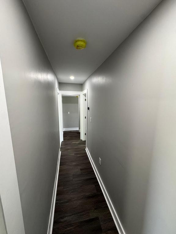 32 Main St, Monson, MA 01057 - hallway with baseboards and dark wood-style flooring