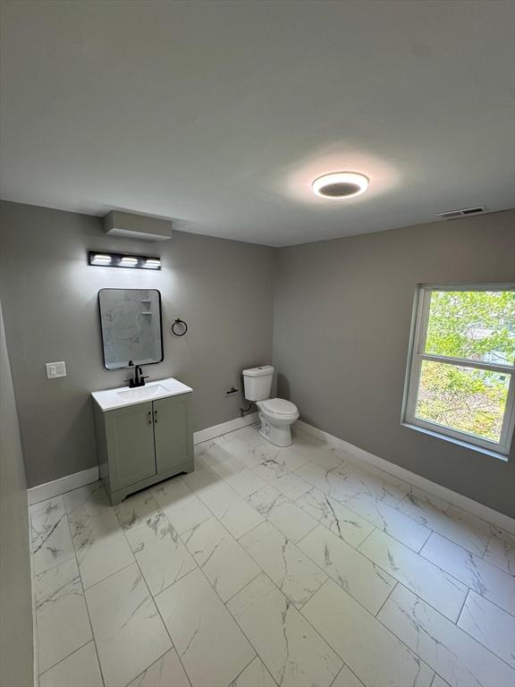 32 Main St, Monson, MA 01057 - half bathroom featuring vanity and marble finish floors