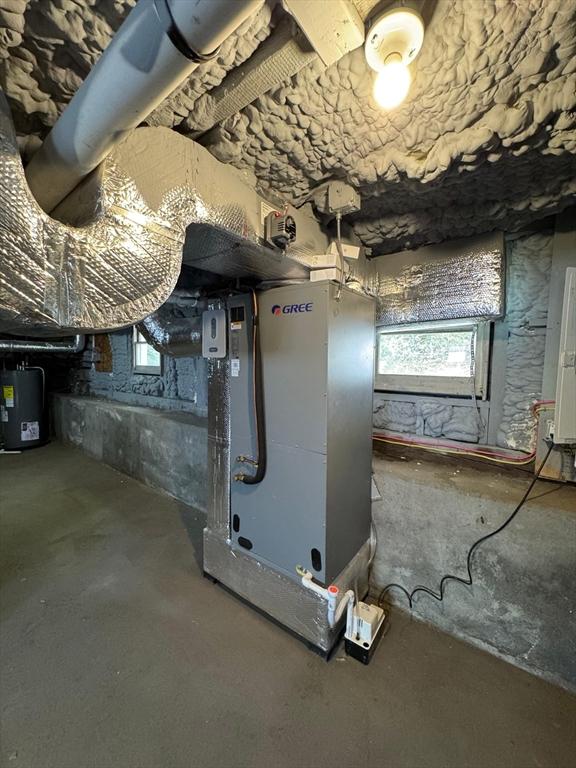 32 Main St, Monson, MA 01057 - below grade area featuring water heater, plenty of natural light, and heating unit