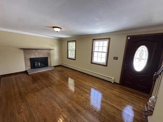 foyer entrance with ornamental molding, a baseboard heating unit, and dark wood-type flooring