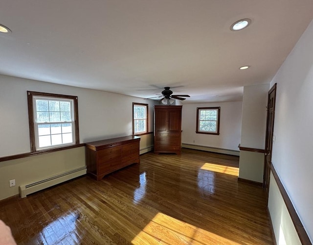 unfurnished room with baseboard heating, ceiling fan, and hardwood / wood-style floors