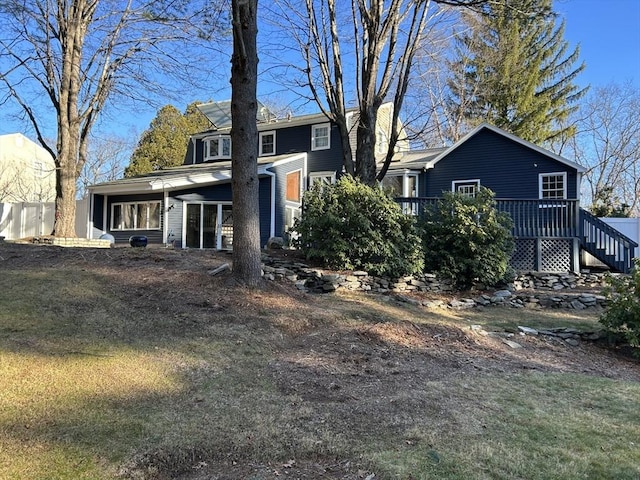 rear view of house with a wooden deck