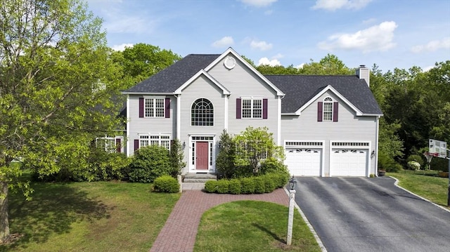 18 Preserve Way, Sturbridge, MA 01566 - colonial-style house featuring driveway, a chimney, a front lawn, and an attached garage
