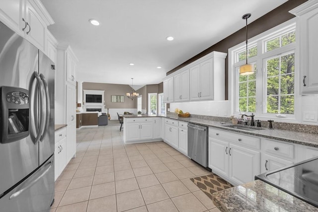 18 Preserve Way, Sturbridge, MA 01566 - kitchen with stainless steel appliances, healthy amount of natural light, light tile patterned flooring, white cabinetry, and recessed lighting