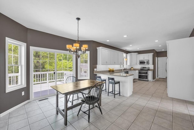 18 Preserve Way, Sturbridge, MA 01566 - dining space featuring a chandelier, healthy amount of natural light, light tile patterned flooring, recessed lighting, and baseboards