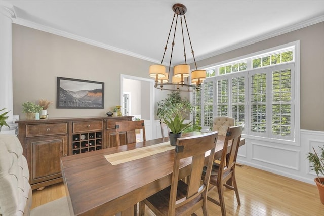 18 Preserve Way, Sturbridge, MA 01566 - dining area featuring a chandelier, light wood-type flooring, ornamental molding, a decorative wall, and wainscoting