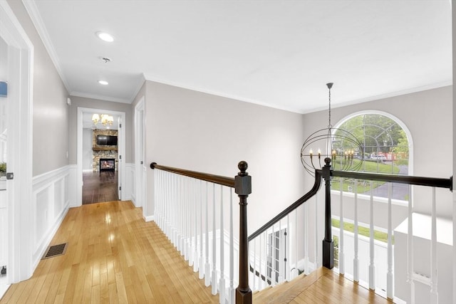 18 Preserve Way, Sturbridge, MA 01566 - hallway featuring a chandelier, an upstairs landing, light wood-style flooring, wainscoting, and recessed lighting