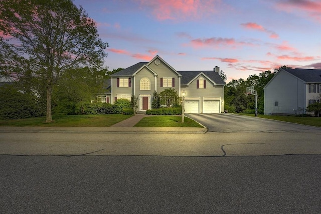 18 Preserve Way, Sturbridge, MA 01566 - traditional home featuring an attached garage, asphalt driveway, a chimney, and a lawn