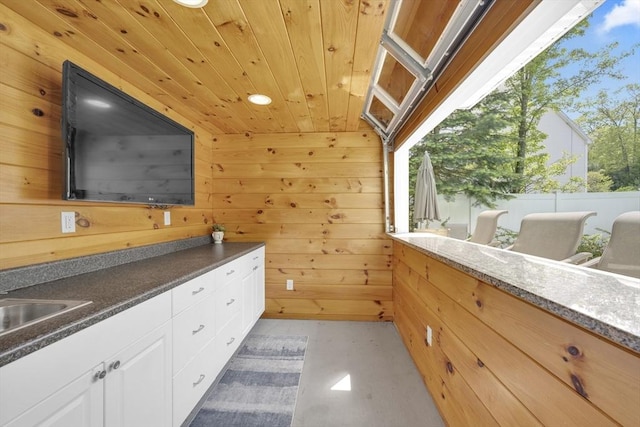 18 Preserve Way, Sturbridge, MA 01566 - bathroom with wood ceiling, wooden walls, concrete floors, and a sink