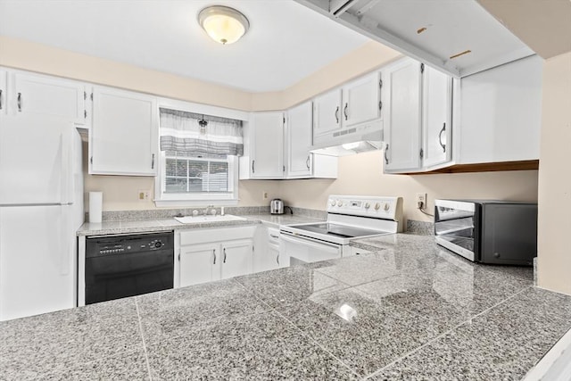 kitchen with white appliances, under cabinet range hood, tile counters, a sink, and white cabinets