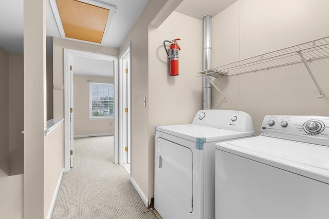 laundry room with washer and dryer, baseboards, and light carpet