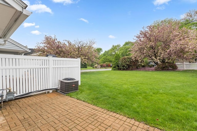 view of yard with cooling unit and a patio area