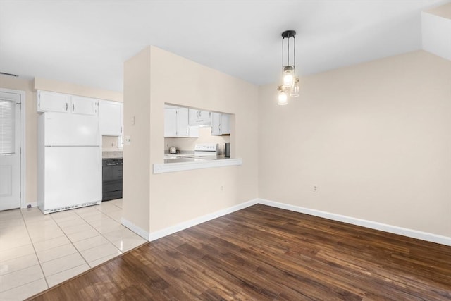 unfurnished dining area with wood finished floors and baseboards
